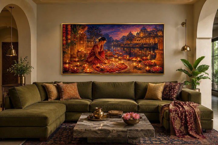 Diwali canvas wall art of a woman lighting diyas above an olive green sofa in a living room.