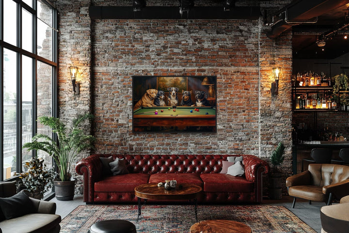 Dogs Playing Pool framed canvas wall art hanging on a brick wall above a red leather sofa.
