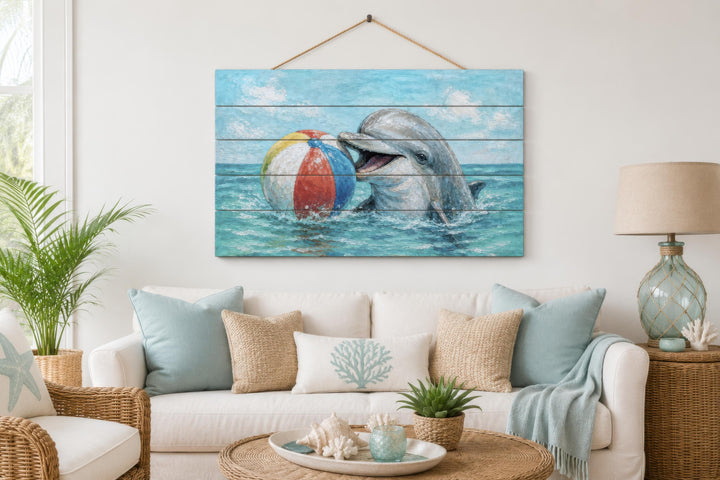 Dolphin and beach ball print on distressed wood planks hanging in a coastal living room.