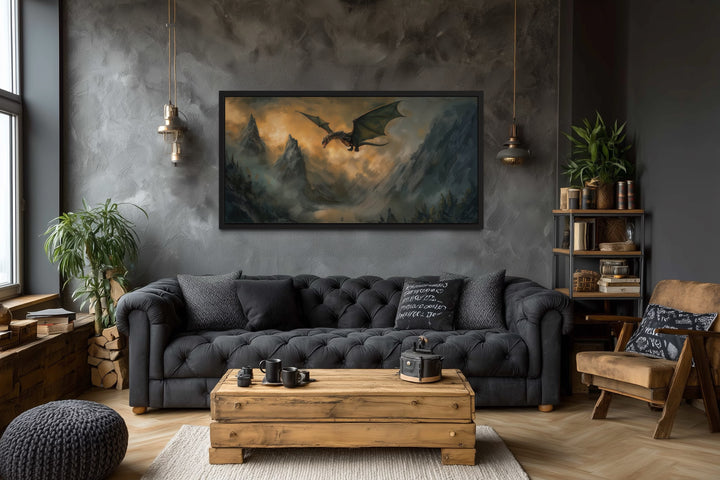 Framed panoramic canvas wall art of a dragon flying over misty mountains in a dark living room.