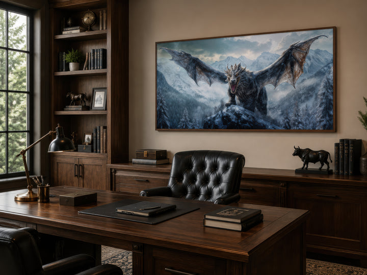 Framed dragon canvas wall art depicting a dragon in snowy mountains above a dark wood office desk.