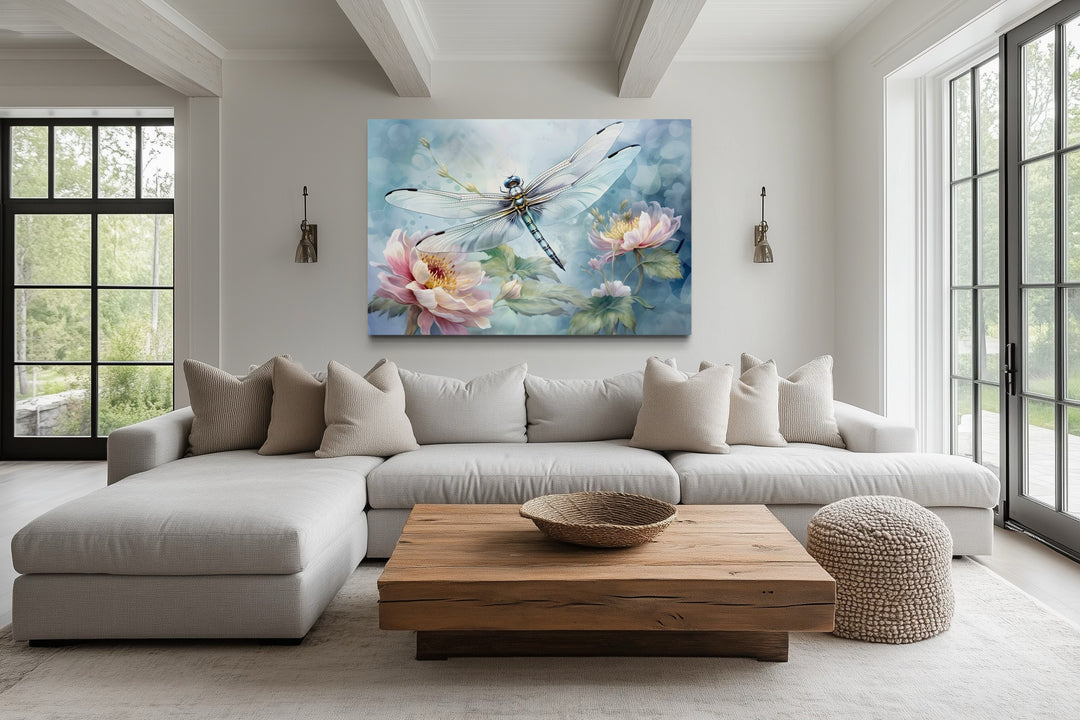 Dragonfly on flower watercolor wall art in a farmhouse living room above a white sectional sofa.