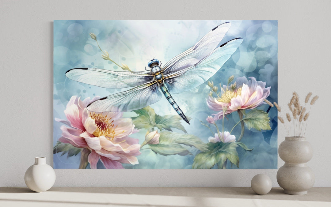 Shabby chic watercolor wall art of a dragonfly over pink flowers on a blue background.