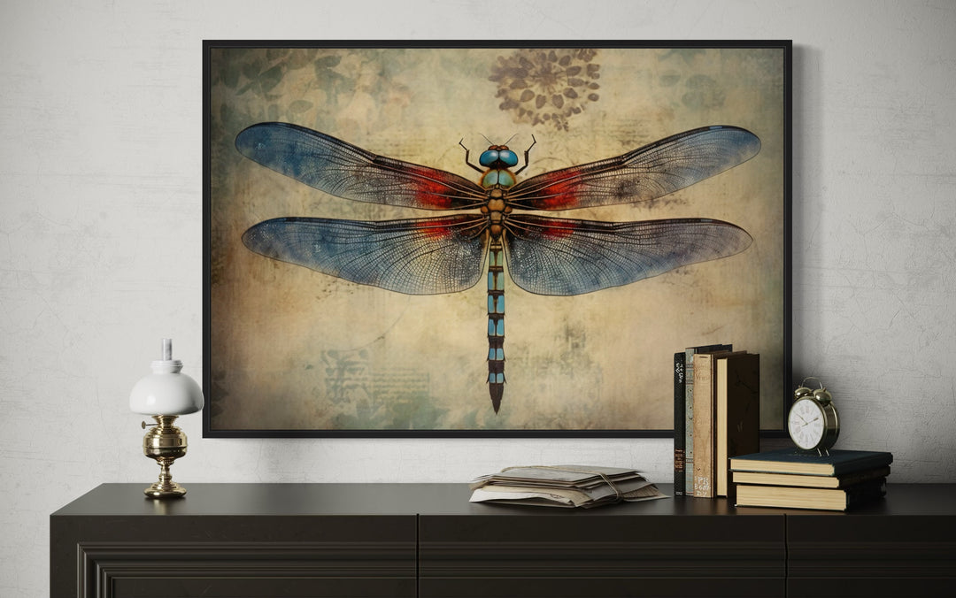 Dragonfly Vintage Rustic Framed Canvas Wall Art above a dark wood console with books and a lamp.