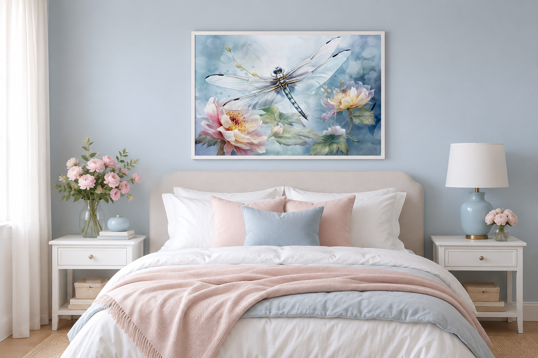 Dragonfly on flower watercolor wall art in a white frame above a bed with pink and blue bedding.