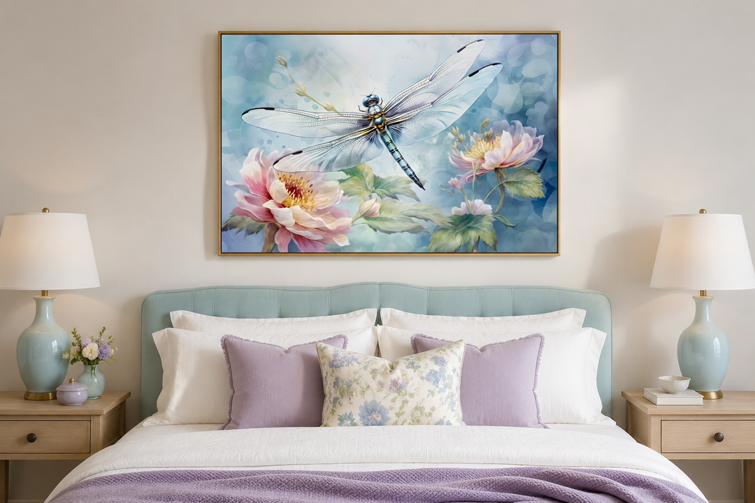 Framed watercolor dragonfly and flower wall art above a bed with lavender and floral pillows.