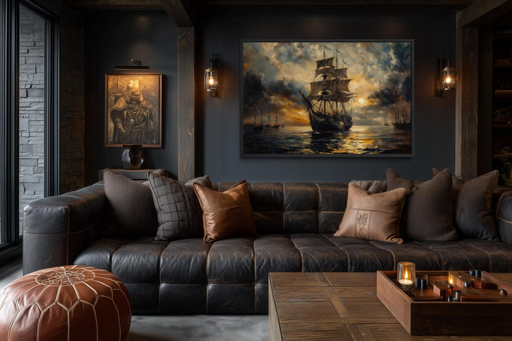 Dramatic black and gold sailing ship canvas wall art in a masculine office with leather sofa.