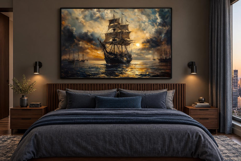 Dramatic black and gold sailing ship framed canvas wall art hanging above a modern bed.