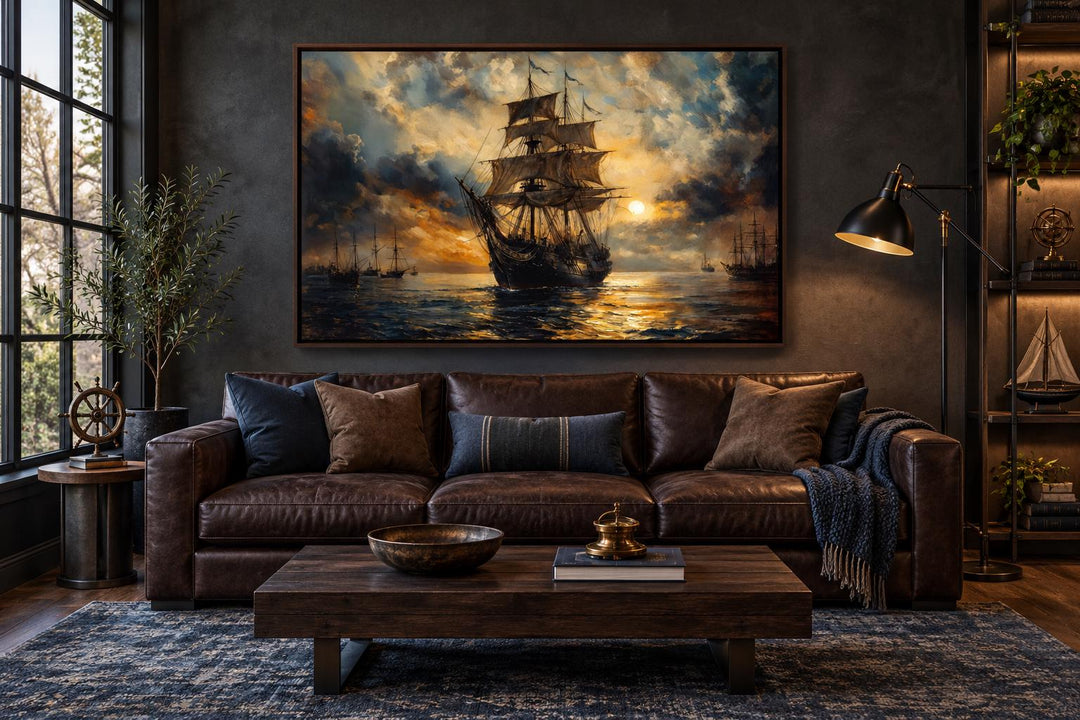 Dramatic black and gold ship framed canvas wall art in a masculine office with leather sofa.
