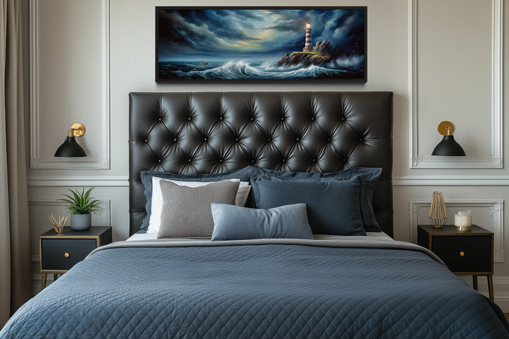 Dramatic long horizontal wall art of a lighthouse in a stormy ocean above a tufted headboard.