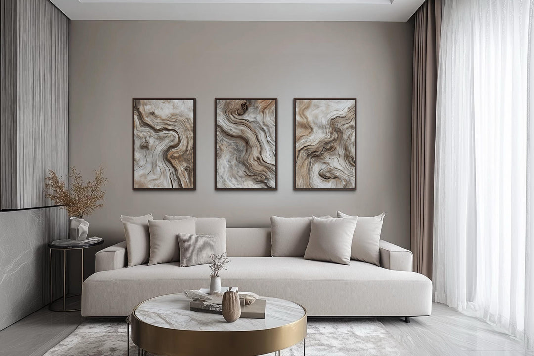 Set of three vertical canvas wall art panels featuring abstract driftwood grain in warm neutrals.