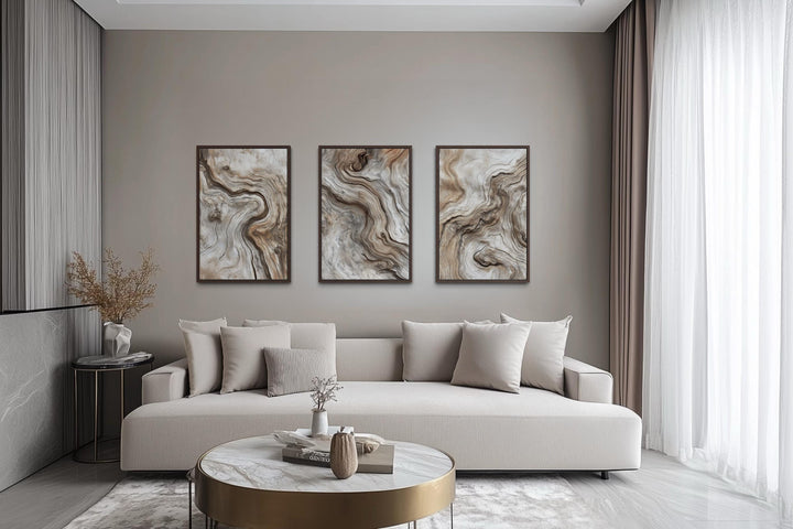 Set of three vertical canvas wall art panels featuring abstract driftwood grain in warm neutrals.