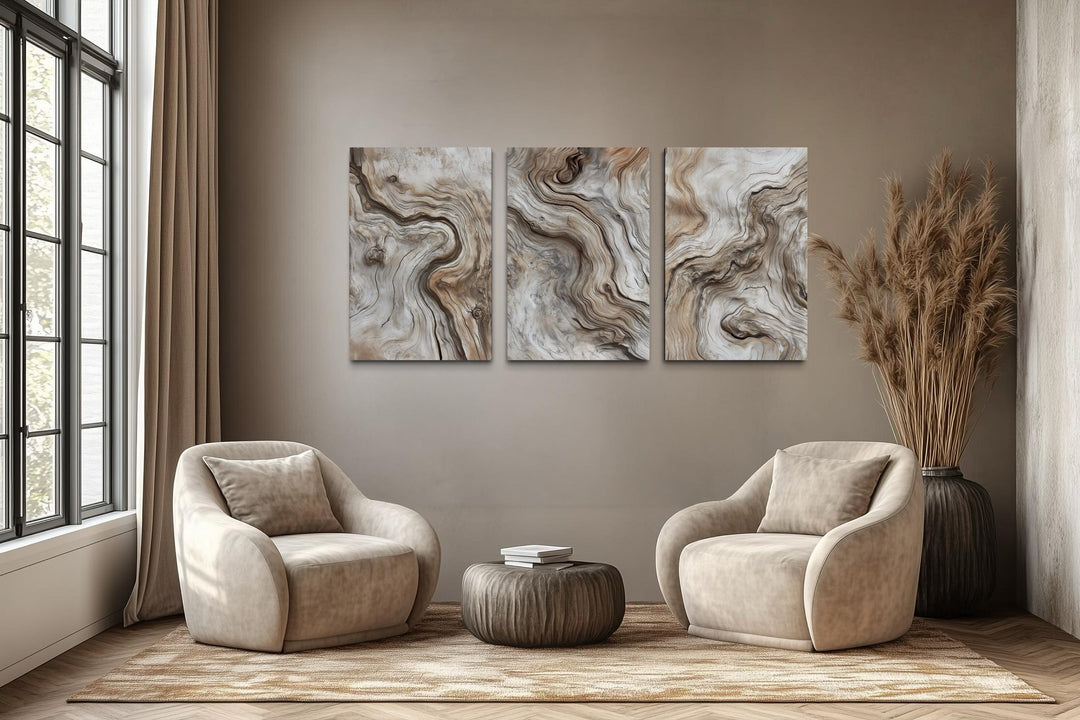 A triptych of vertical canvas wall art featuring abstract driftwood grain patterns in a modern room.
