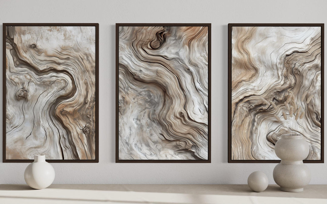 A triptych of three vertical canvas wall art pieces featuring abstract driftwood grain patterns.