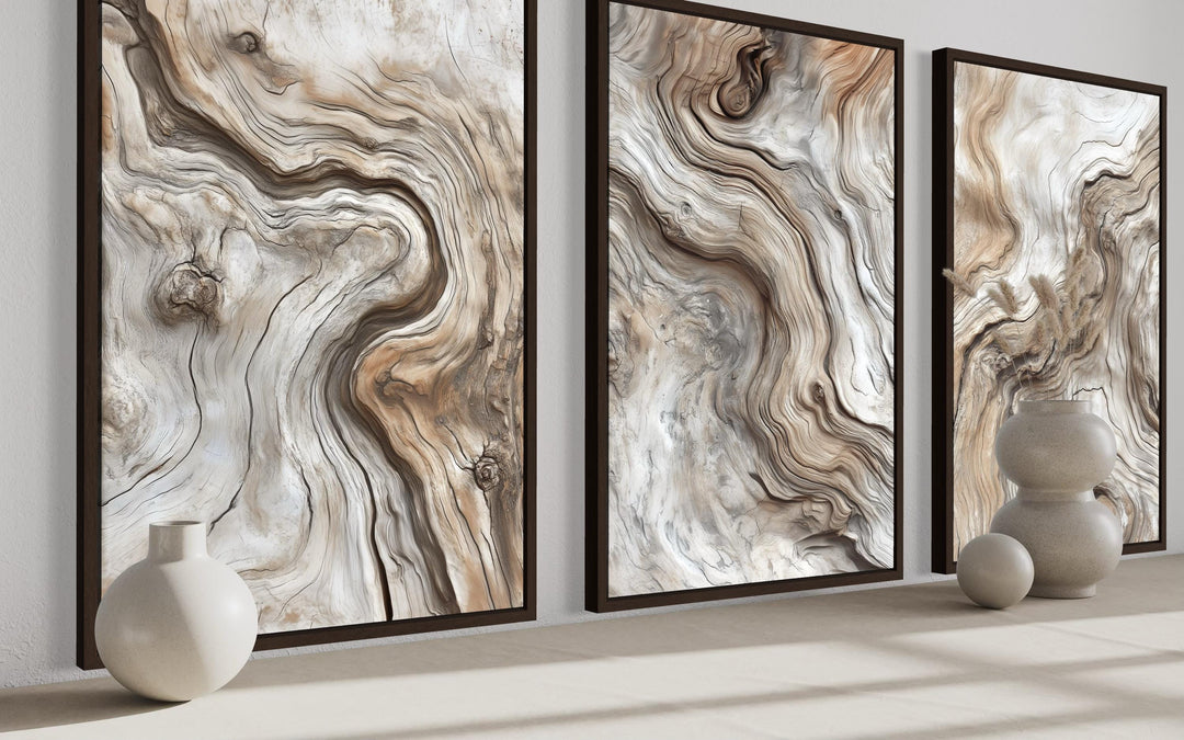 A triptych of vertical canvas wall art featuring abstract driftwood grain patterns in warm tones.