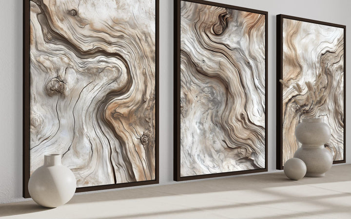 A triptych of vertical canvas wall art featuring abstract driftwood grain patterns in warm tones.
