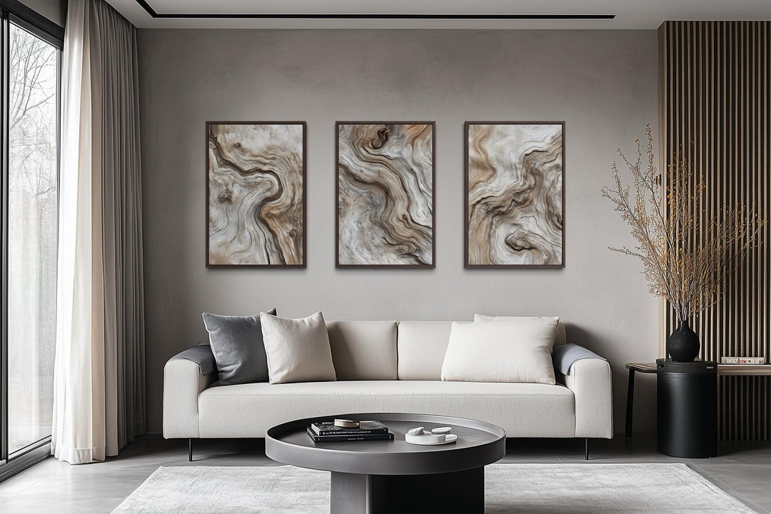 Set of three vertical canvas wall art panels featuring abstract driftwood grain in warm wood tones.