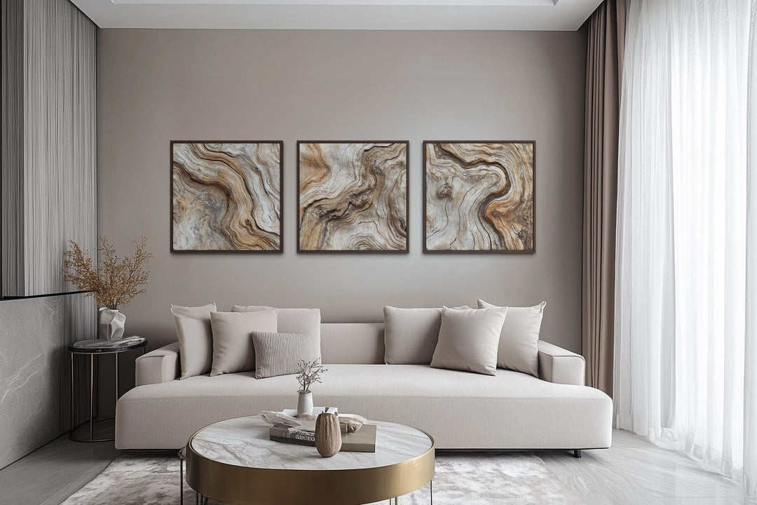 Set of three driftwood wood grain canvas wall art panels in a modern neutral living room.