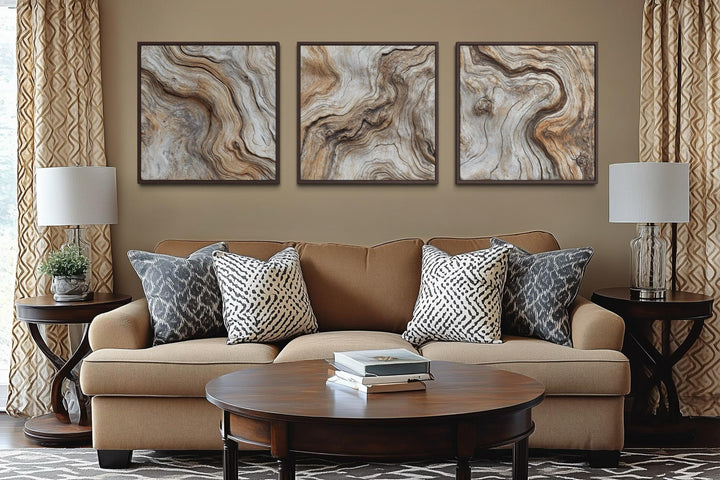 Triptych of three square driftwood wood grain canvas paintings in a warm, neutral living room.