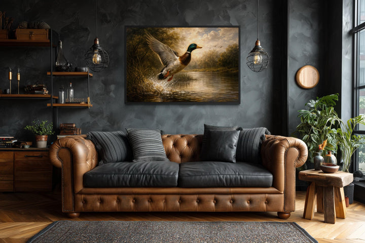 A framed canvas print of a mallard duck in flight over a river, hung in a rustic living room.