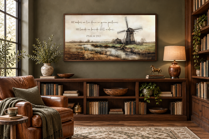 Psalm 23:2 Scripture wall art featuring a windmill and river landscape in a dark wood frame.