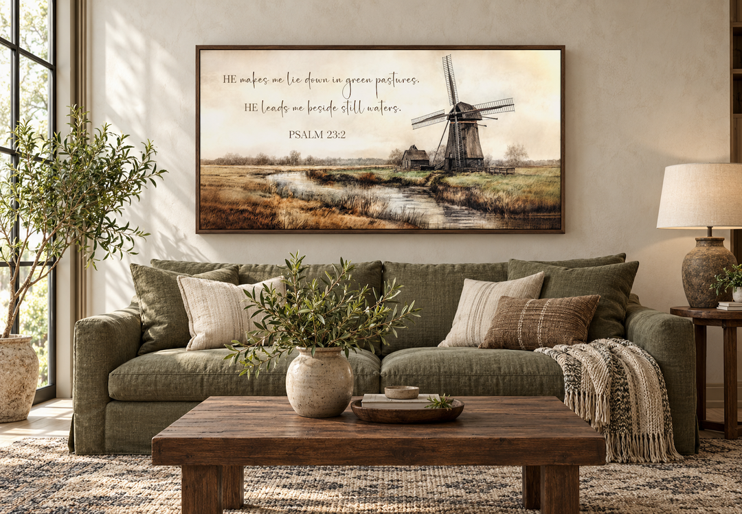 Psalm 23:2 scripture wall art featuring a windmill and river landscape in a rustic living room.