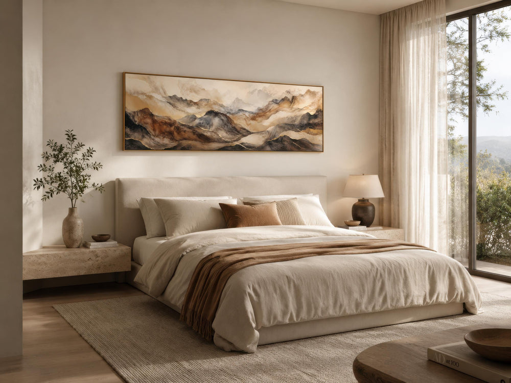 Long horizontal canvas with earthy brown and gold abstract mountain art above a neutral bed.