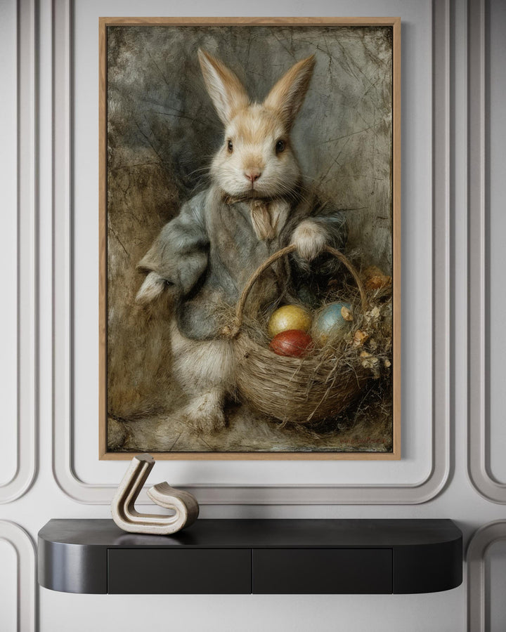 Vintage rabbit painting in a wooden frame featuring a bunny with a basket of Easter eggs.
