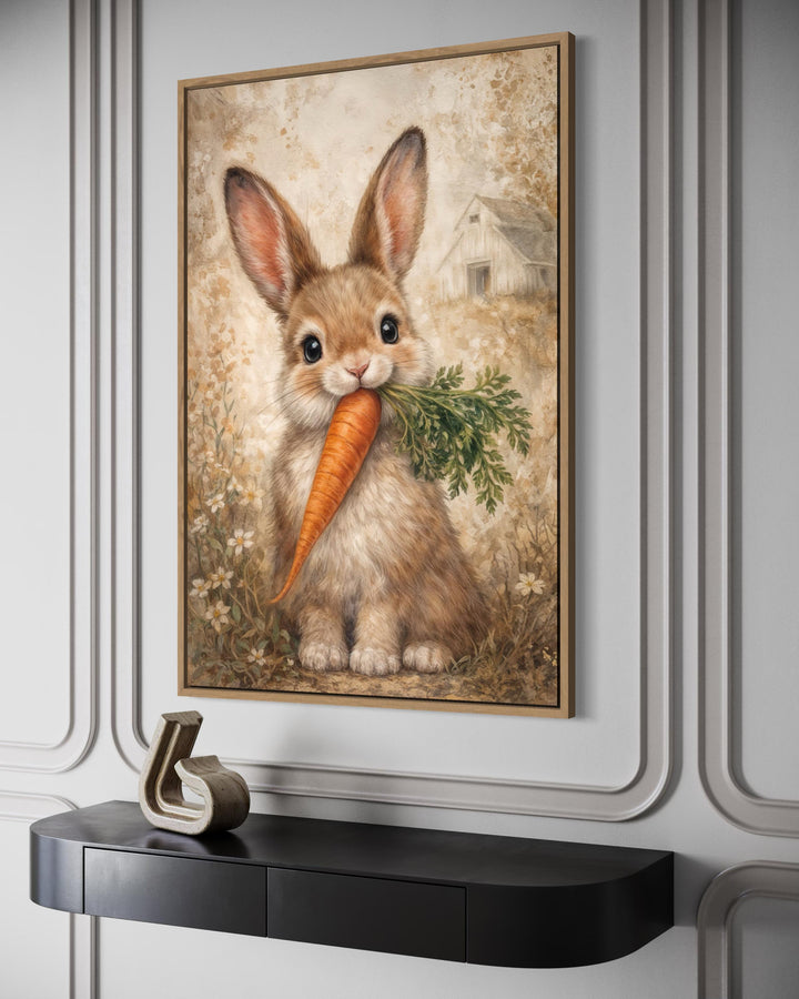 Framed canvas wall art of a neutral-toned bunny holding a carrot in a rustic farmhouse style.
