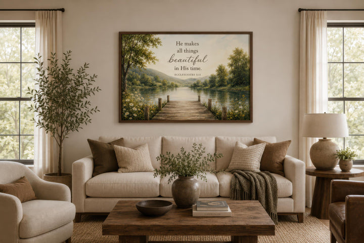 Ecclesiastes 3:11 scripture on rustic canvas wall art above a sofa in a neutral living room.