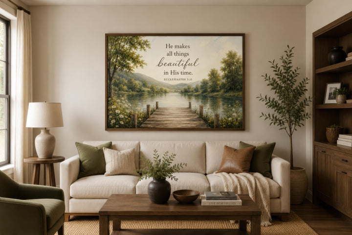 Ecclesiastes 3:11 scripture on rustic canvas wall art above a sofa in a warm, neutral living room.