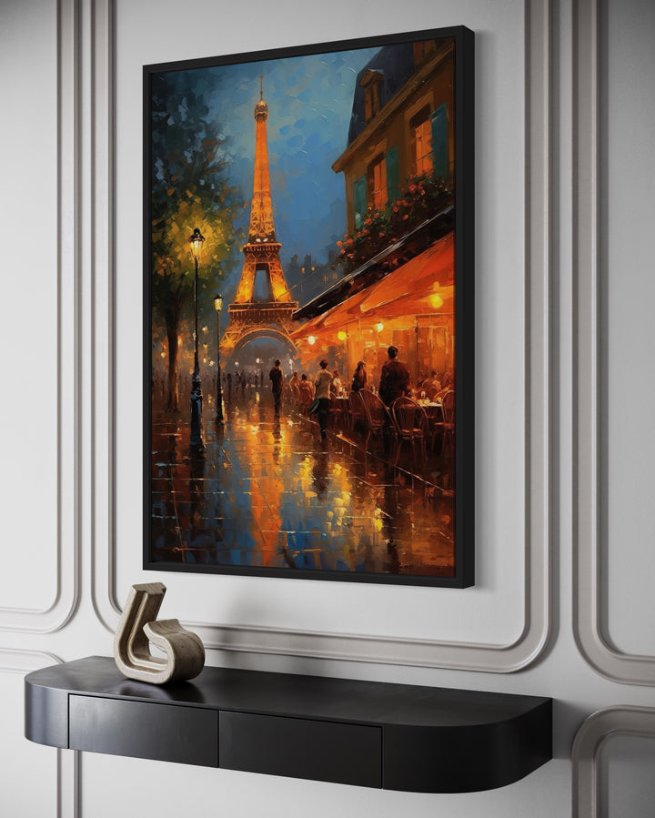 Eiffel Tower and Paris street cafe oil painting on framed canvas above a black console table.