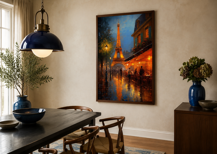 Framed canvas wall art of the Eiffel Tower and a glowing Paris street cafe in a dining room.
