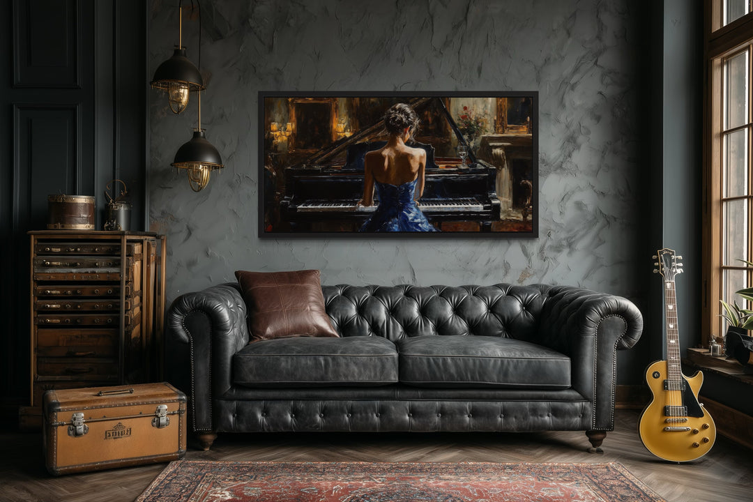 Canvas wall art of a woman in a blue dress playing a grand piano, hung above a black leather sofa.