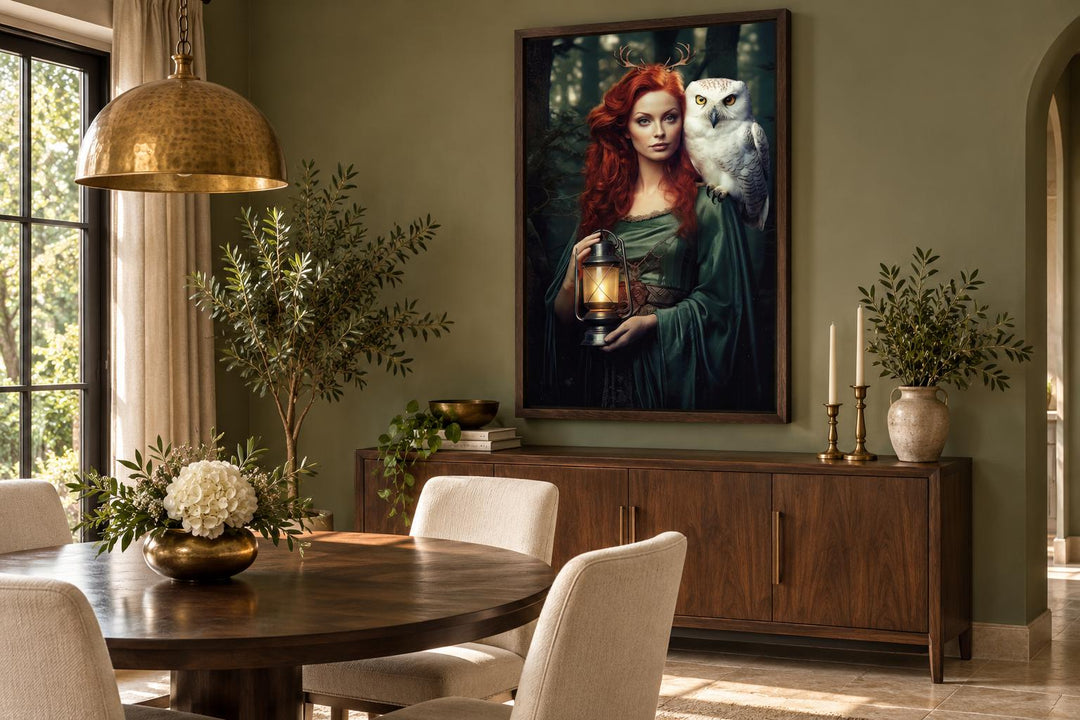 Framed canvas art of Elen of the Ways goddess with a white owl and lantern in a dining room.