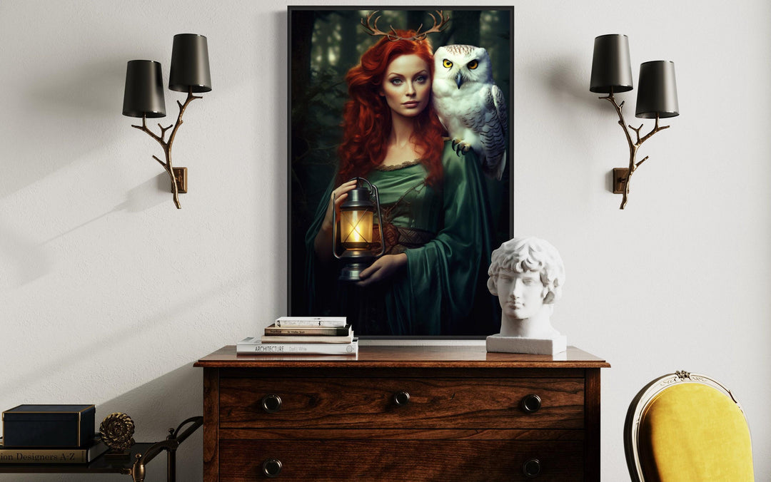 Elen of the Ways framed canvas art featuring an antlered woman and white owl above a wooden dresser.