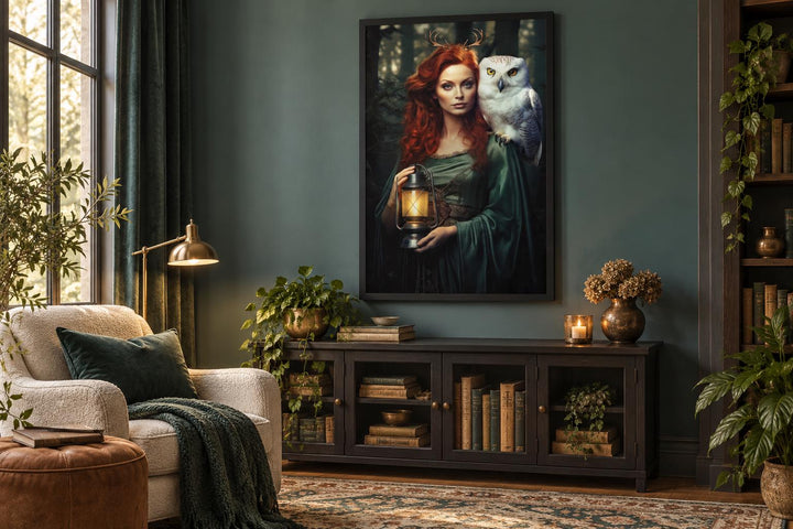 Framed canvas art of Elen of the Ways goddess with a white owl and lantern in a moody living room.