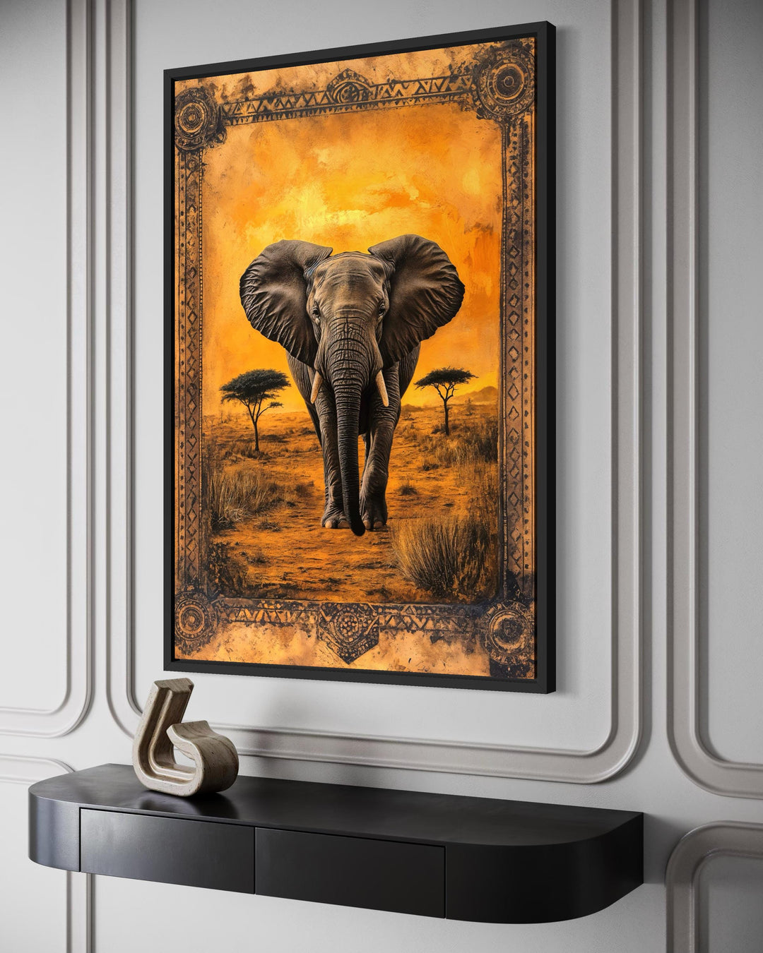 Framed canvas wall art of an elephant in the African savanna at sunset with an ornate border.