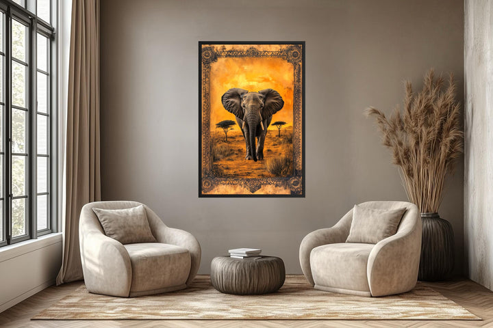 A framed canvas print of an elephant in the African savanna at sunset hangs in a modern living room.