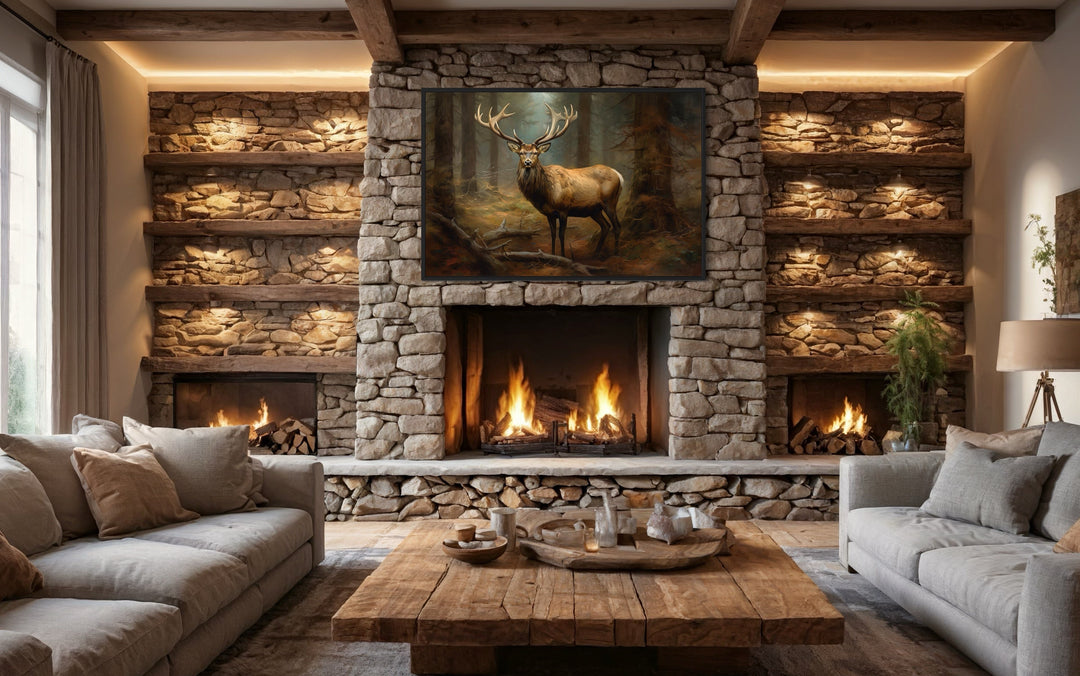 Framed canvas wall art of an elk in a fir tree forest hanging above a rustic stone fireplace.
