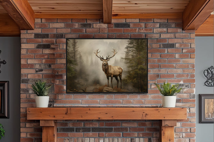 Elk in a misty fir forest painting framed above a fireplace mantel with potted plants.
