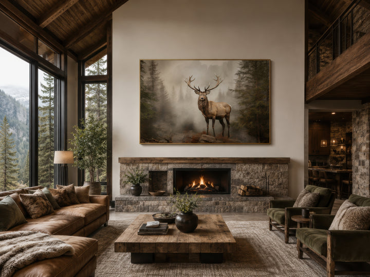 Elk in a misty fir tree forest painting displayed above a stone fireplace in a rustic cabin.
