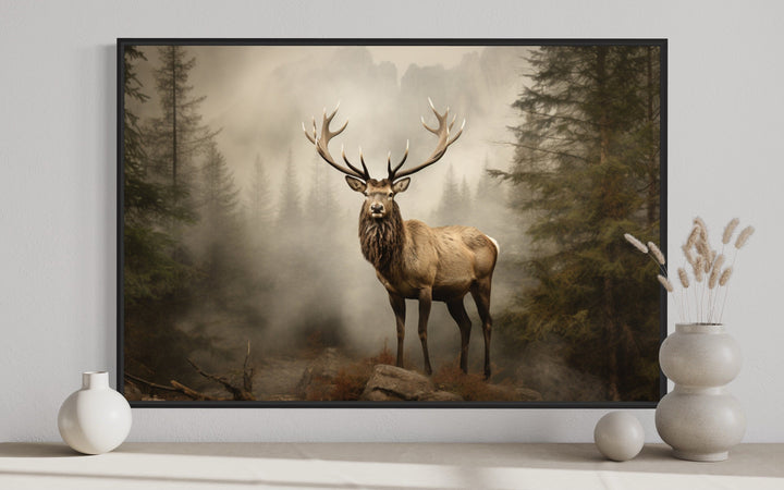 Elk in a misty fir tree forest painting, rustic wildlife wall art in a black frame.
