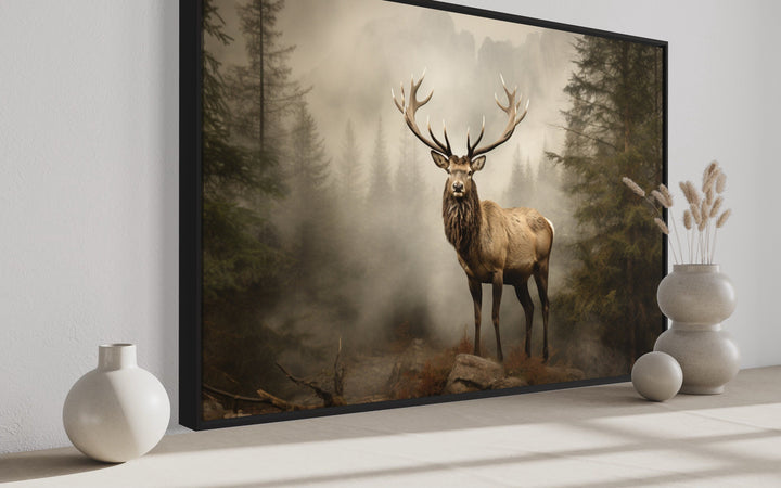 Framed elk painting in a misty fir tree forest, rustic wildlife wall art for cabin decor.