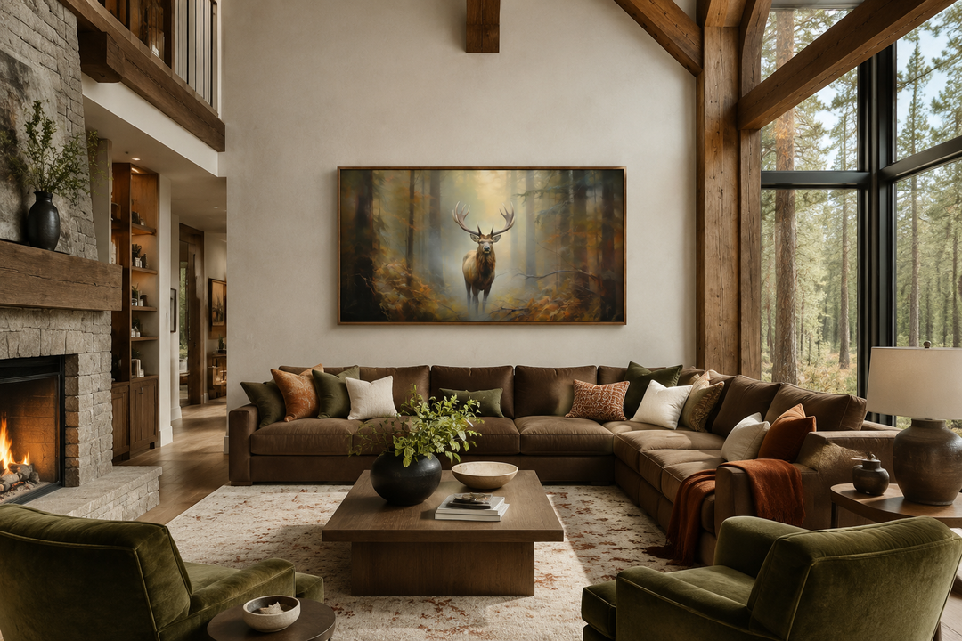 Large framed canvas wall art of a majestic elk in a foggy forest above a brown sectional sofa.