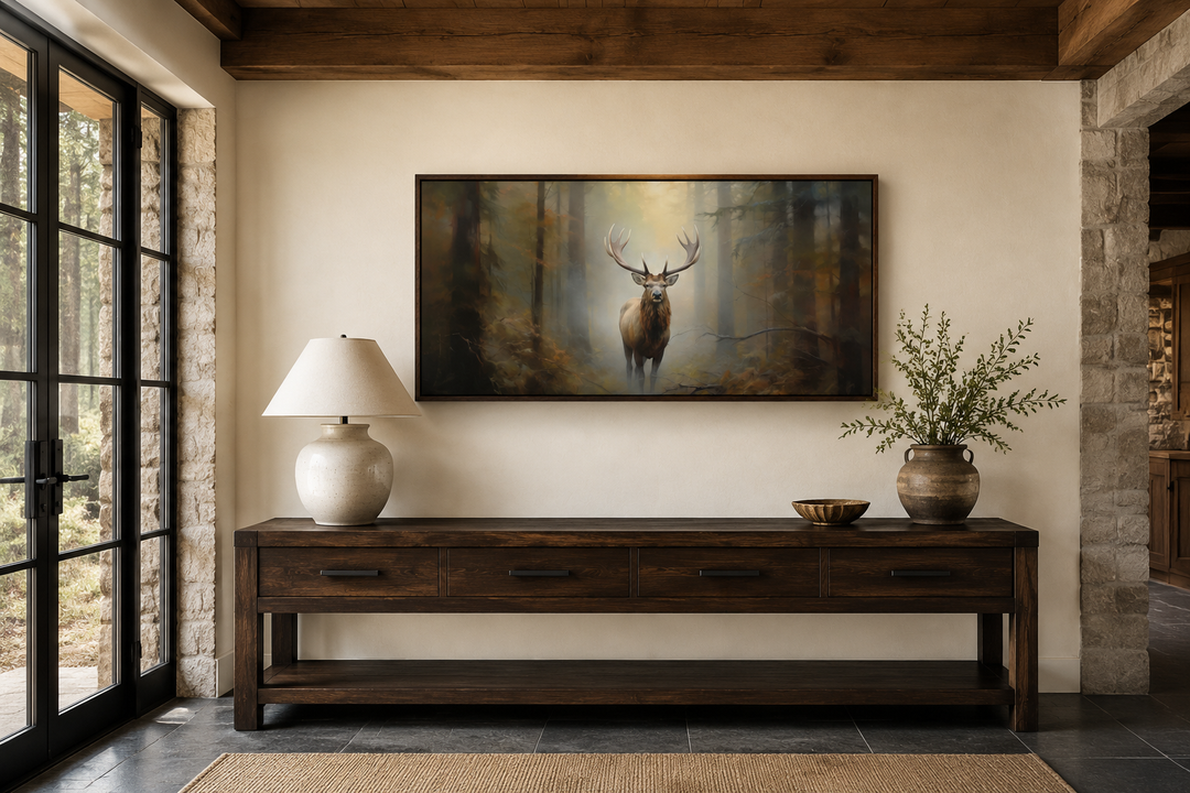Large framed canvas wall art of a majestic elk in a foggy forest above a rustic wooden sideboard.
