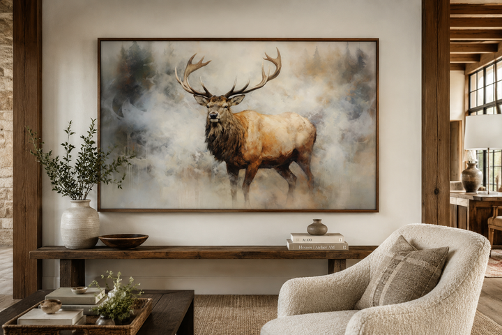 Framed canvas wall art of a majestic elk in a misty forest above a rustic wooden console table.