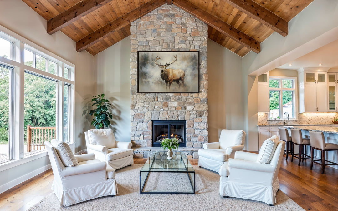 Elk in smokey forest canvas wall art hanging above a stone fireplace in a rustic living room.
