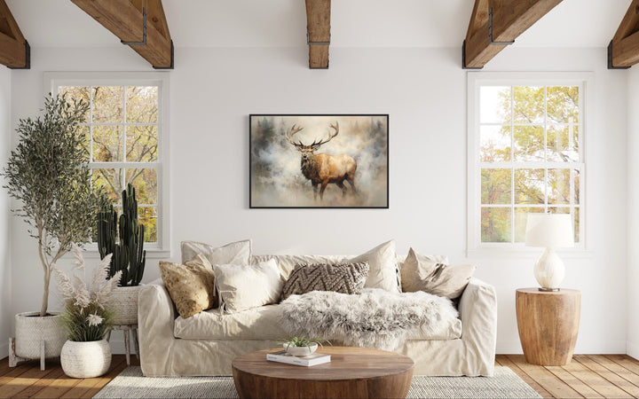 Elk in smokey forest canvas wall art hanging above a sofa in a rustic cabin living room.