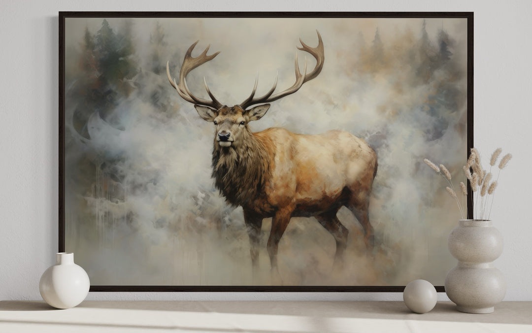 Framed canvas wall art of a majestic elk with large antlers in a misty, smoky forest setting.